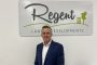 Tony Broome standing in front of Regent Land & Developments sign